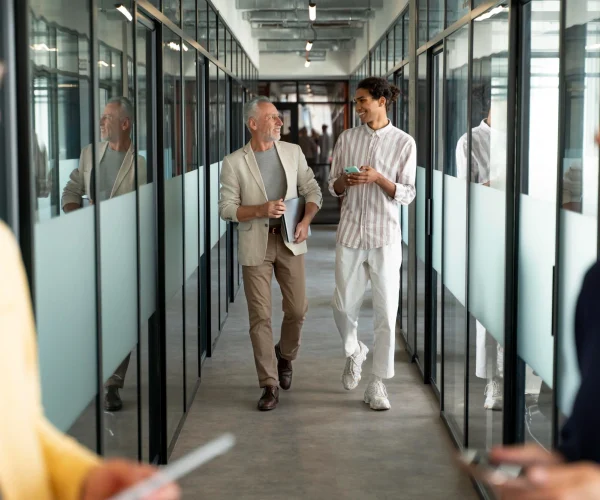 A Man And Woman Walking Down A Hallway