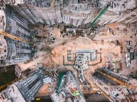 a construction site with cranes and buildings