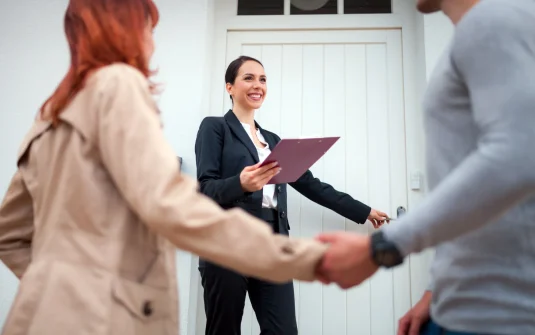 A Woman Holding A Clipboard And A Man Shaking Hands