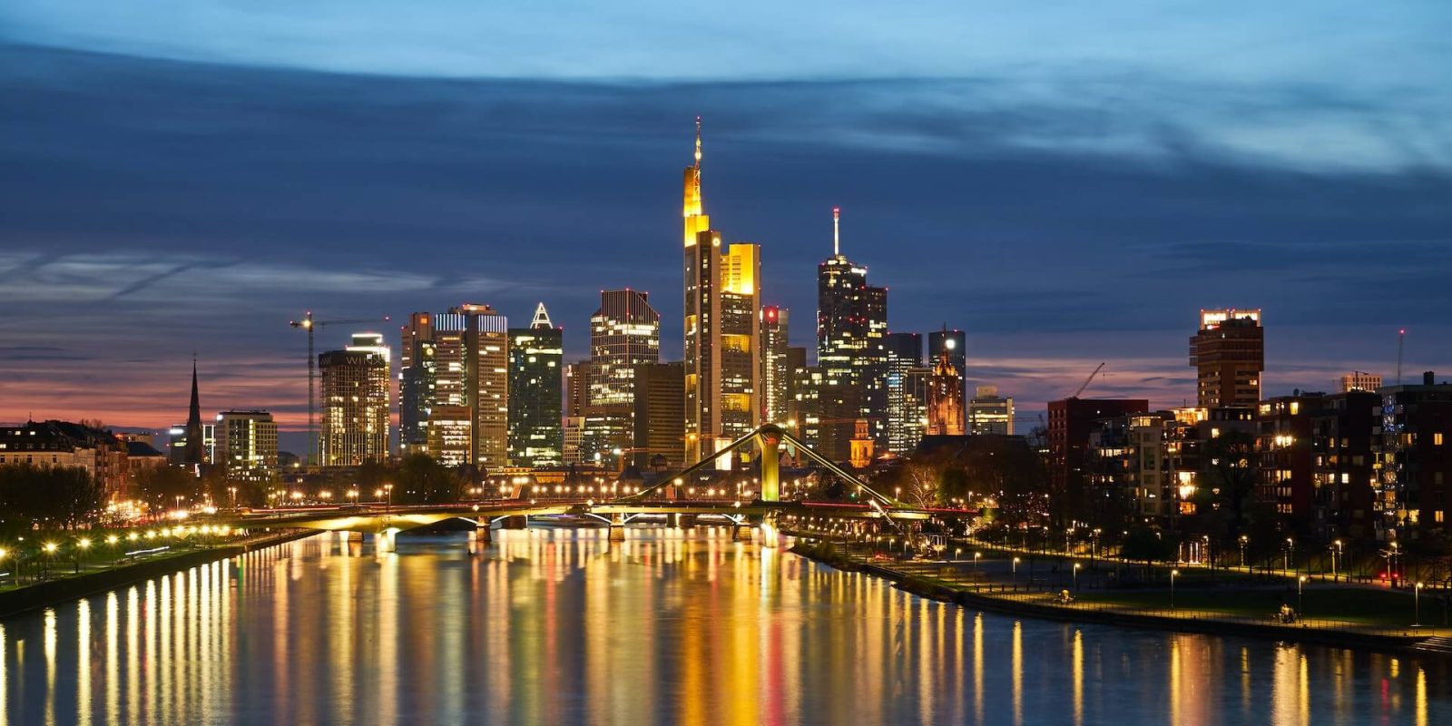 a city skyline with lights reflecting on water