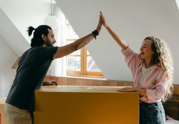 a man and woman giving each other a high five