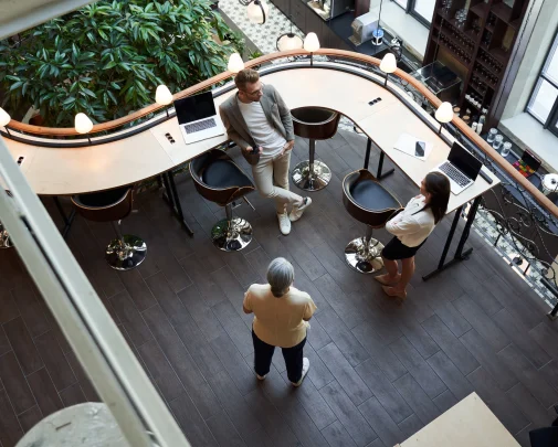 A Group Of People Standing Around A Bar